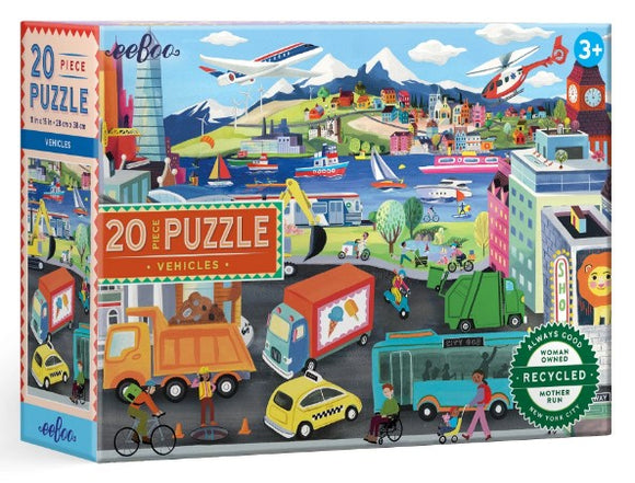 Eeboo's Vehicles 20 Piece Puzzle showcases a vibrant illustration of various vehicles including trucks, bikes, and airplanes, set against a colorful landscape of mountains, buildings, and water. Suitable for ages 3 and up, this eco-friendly puzzle features engaging artwork designed to stimulate children's imaginations and encourage problem-solving skills.
