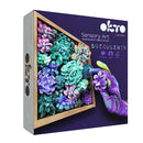 DIY Succulents Clay Kit by OKTO Clay featuring a vibrant assortment of colorful clay succulents arranged in a wooden frame. The kit promotes creativity and sensory art, ideal for relaxation and art therapy activities.