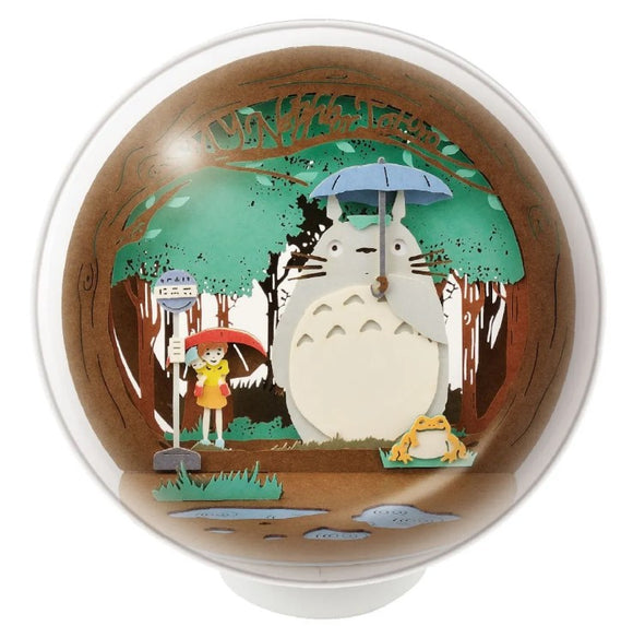 A charming diorama of Totoro at the bus stop, featuring Totoro holding an umbrella, a girl in a yellow raincoat, and a frog. The vibrant colors and intricate details capture the essence of this beloved scene from the Studio Ghibli film.