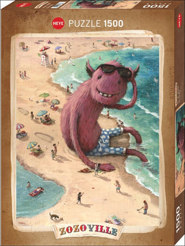 Zozoville Beach Boy jigsaw puzzle featuring a whimsical illustration of a large, pink, furry creature wearing sunglasses, relaxing by the beach among beachgoers. The scene includes people sunbathing, children playing, and colorful beach umbrellas, all set against a vibrant ocean backdrop. Puzzle consists of 1500 pieces.
