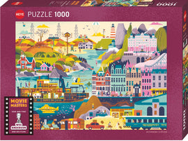 Wes Anderson Films jigsaw puzzle by Heye featuring a vibrant, colorful illustration depicting iconic scenes from various Wes Anderson movies. The design includes whimsical buildings, lush landscapes, charming vehicles, and playful characters, all rendered in a unique, stylized art style. This 1000-piece puzzle offers a delightful challenge for fans of Anderson's films.