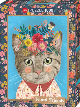 Jigsaw puzzle titled 'Floral Friends' by Heye, featuring an illustrated feline with a floral crown on a vibrant blue background. The cat is depicted in a patterned shirt, surrounded by colorful flowers and greenery.
