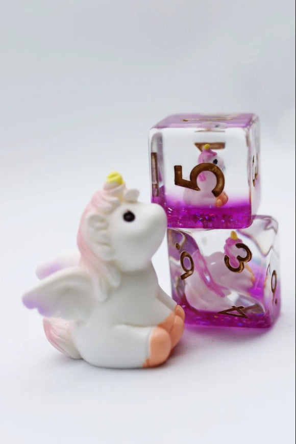 The Mystic Unicorn RPG Dice Set features whimsical designs with a playful unicorn figurine sitting beside sparkly purple dice featuring numbers 3, 4, 5, and 6. The set adds enchantment to any tabletop RPG experience, enhancing gameplay with its unique aesthetics.
