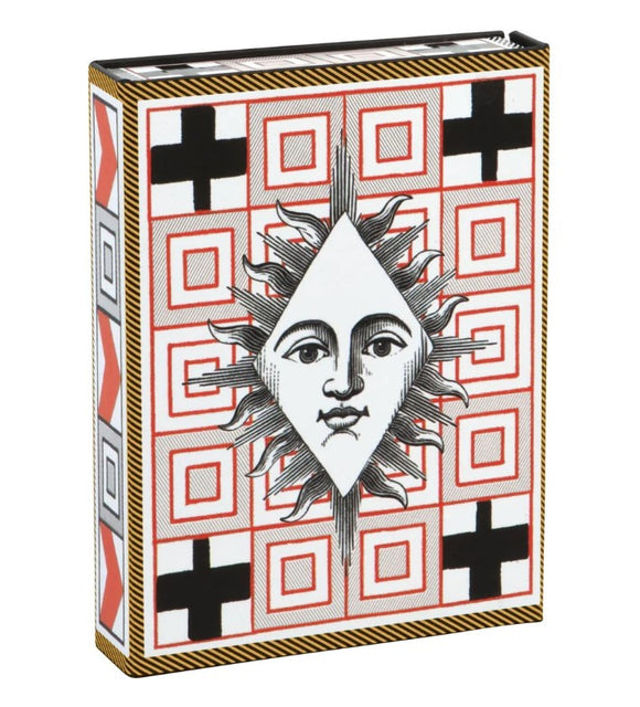 Elegant box of Christian Lacroix Playing Cards featuring a striking design with a sun motif surrounded by geometric patterns in red and black. Perfect for a stylish game night.