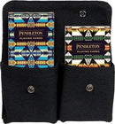 Pendleton Playing Cards set featuring two decks each with unique and colorful tribal patterns, housed in a black fabric case with snap closures. Ideal for game nights, the cards showcase rich designs inspired by traditional Pendleton patterns.