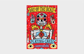 Colorful packaging of the Day of the Dead Playing Cards designed by Ricardo Cavolo. The design features a vibrant skeleton surrounded by flowers, candles, and other festive elements against a bright red background.