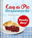 Cover of the 'Totally Easy! Easy as Pie Crosswords' book featuring a slice of cherry pie on a plate. The title is prominently displayed in red and blue lettering against a light blue background, with a spiral binding visible on the side.