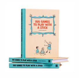 A colorful book titled '100 Games to Play with a Stick' displayed prominently. The book features children engaging in playful activities outdoors. The stack of books has the same title on their spines, showcasing a fun and engaging collection of outdoor games suitable for kids. The design has a vintage feel that appeals to parents looking for nostalgic activities.