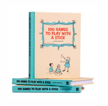 A colorful book titled '100 Games to Play with a Stick' displayed prominently. The book features children engaging in playful activities outdoors. The stack of books has the same title on their spines, showcasing a fun and engaging collection of outdoor games suitable for kids. The design has a vintage feel that appeals to parents looking for nostalgic activities.