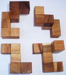 Coffin's Four-Piece Cube by Bill Sheckles is a mechanical puzzle featuring four distinct wooden shapes that can be combined in various ways. The pieces have a natural wood finish, showcasing rich textures and tones. This puzzle challenges spatial reasoning and problem-solving skills, making it an engaging and thoughtful activity for puzzle enthusiasts.