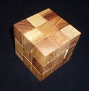 Coffin's Four-Piece Cube by Bill Sheckles, a mechanical puzzle made of various shades of wood, intricately designed with a symmetrical cube shape featuring interlocking pieces that challenge problem-solving skills.