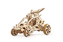 Ugears 3D Mini Desert Buggy DIY kit features an intricately designed wooden model in the shape of a mini buggy. This mechanical model showcases detailed craftsmanship with visible gears and wheels, perfect for enthusiasts looking for a creative challenge.