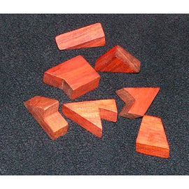 A collection of eight wooden pieces in various geometric shapes, crafted from reddish-brown wood. They are designed as a mechanical puzzle for two players, showcasing an assortment of angles and edges, perfect for brain-teasing fun.