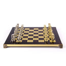 A beautifully crafted 15-inch chess set featuring gold Minoan warrior pieces and a glossy black and gold checkerboard. The board is adorned with intricate detailing on the edges, showcasing a luxurious design perfect for collectors and chess enthusiasts.