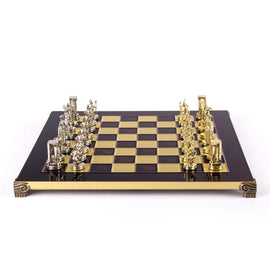 A beautifully crafted 15-inch chess set featuring gold Minoan warrior pieces and a glossy black and gold checkerboard. The board is adorned with intricate detailing on the edges, showcasing a luxurious design perfect for collectors and chess enthusiasts.