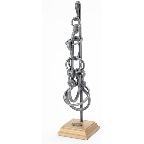 The Best Ever Tavern Puzzle by Tucker Jones House is a mechanical puzzle featuring multiple interlocking rings, beautifully crafted from metal and mounted on a wooden base. This intricate design challenges puzzlers with its unique shape and requires problem-solving skills to separate the pieces. Ideal for collectors or those seeking a stimulating brain teaser.