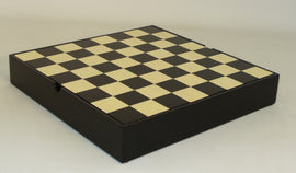 A 13.25-inch chess board featuring a black and maple design, showcasing alternating squares. The board is compact and designed for storage, ideal for chess enthusiasts.
