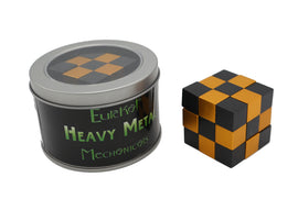 Heavy Metal: Copperhead by Eureka Puzzles. This intricate mechanical puzzle features a cube design with alternating black and metallic copper squares. The puzzle is presented in a sleek, circular tin container with a transparent lid, allowing visibility of the puzzle inside. Ideal for puzzle enthusiasts seeking a challenging and visually appealing experience.