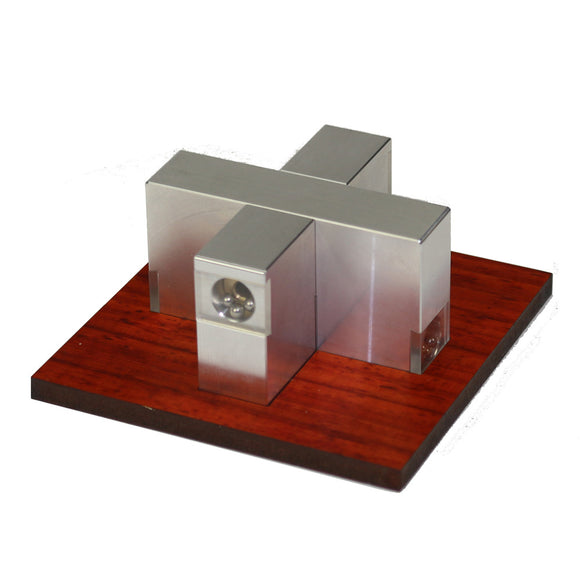 Aluminum Sweta Cross mechanical puzzle by W.G.H. Strijbos displayed on a wooden base. The puzzle features a unique cross-shaped design with polished aluminum blocks and small spheres, emphasizing both creativity and engineering.