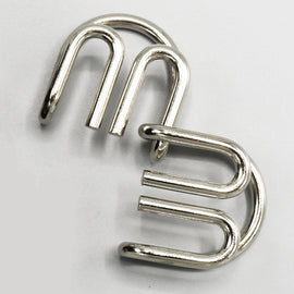 Double M Mechanical puzzle by Eureka Puzzles featuring two interlocking metal components. The design emphasizes intricate patterns and is crafted for engaging problem-solving.