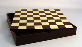 16.5-inch chess board featuring a classic black and maple checkerboard design. The board is housed in a sleek, dark storage chest that keeps chess pieces organized and protected. Ideal for chess enthusiasts and beginners alike, this stylish set combines functionality with timeless elegance.