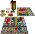 Azul: Stained Glass of Sintra game setup featuring colorful glass-like tiles, a decorative scoring board, and player boards arranged neatly for play. The components include a box with a stained glass design, vibrant tiles in various shapes and colors, and plates for tile placement.
