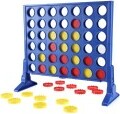 Connect 4 Revised Edition board game by Hasbro, featuring a blue vertical grid and colored discs in red, yellow, and white. The goal is to connect four discs in a row, either horizontally, vertically, or diagonally, while blocking your opponent. The game is laid out with discs scattered around the base and ready for play.