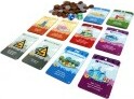 A colorful game display featuring various game cards, each depicting different buildings and landscapes, accompanied by tokens and dice. The vibrant cards showcase unique imagery such as towers, farms, and cityscapes, ideal for a fun family game night.