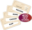Codenames: Duet game featuring playing cards with words like RECORD, BOWL, CAESAR, and RAM. The game encourages teamwork with 400 new words for players to guess.