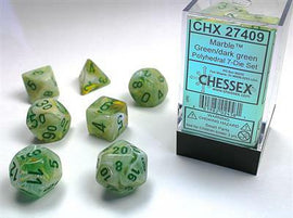 A Chessex Marble green and dark green polyhedral 7-die set, featuring distinct dice shapes including d4, d6, d8, d10, d12, and d20. The dice have a marbled green finish with clear numbering and come in a transparent packaging. Ideal for tabletop games and RPGs.
