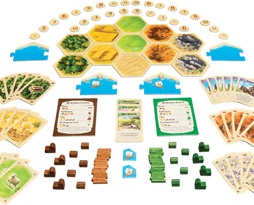 Catan: 5-6 Player Extension board game components including hexagonal terrain tiles, resource cards, building cards, and player pieces in various colors. Designed for expanding gameplay to accommodate up to six players.