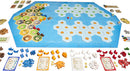 Catan: Explorers & Pirates – 5-6 Player Extension board game setup. Features a hexagonal game board with various resource hexes, player pieces in multiple colors, development cards, and resource tokens laid out. The vibrant game pieces include ships, settlements, and cities, perfect for expanding gameplay for up to six players.