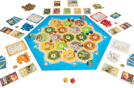 Catan: Traders & Barbarians game by Asmodee, featuring a colorful hexagonal board, player pieces in various colors, resource cards, development cards, and dice, set up for gameplay.