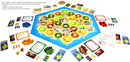 An expansive view of the Catan: Traders & Barbarians – 5-6 Player Extension game set. The board features a hexagonal arrangement with various resources like wood, brick, and wheat. There are player pieces in various colors, including settlements, cities, and roads, alongside resource cards and dice. The setup showcases the additional components needed to accommodate 5-6 players, emphasizing strategic gameplay and resource management.