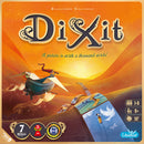 Dixit Refresh (2021) game box featuring imaginative artwork. The cover shows a whimsical landscape with boats and figures set against a vibrant sunset. Includes player details and awards.