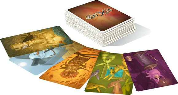 Dixit: Daydreams card game by Asmodee featuring a stack of cards with whimsical illustrations. The game encourages creativity and storytelling through unique artwork, including fantasy themes and vibrant colors.