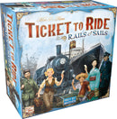 Ticket to Ride: Rails & Sails board game box featuring a vibrant illustration of a train and ship, with characters holding tickets, set against a backdrop of travel and adventure. The box showcases colorful artwork and the Days of Wonder logo.