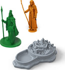 INIS board game featuring colorful character miniatures and a beautifully detailed game board. The set includes a green warrior holding a spear, an orange sorceress wielding a staff, and a gray game board representing a mystical island. Ideal for strategy lovers and game nights, this exciting game invites players to explore Celtic legends and vie for control.
