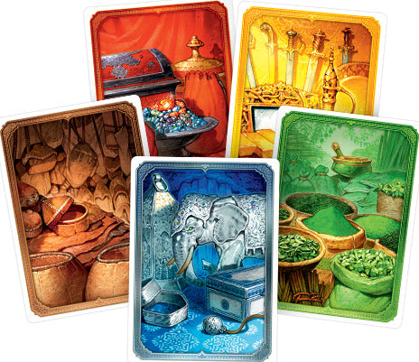 A vibrant display of playing cards from the game Jaipur (New Edition) by Space Cowboys, showcasing colorful illustrations of treasures, an elephant, and exotic items from an Indian marketplace.