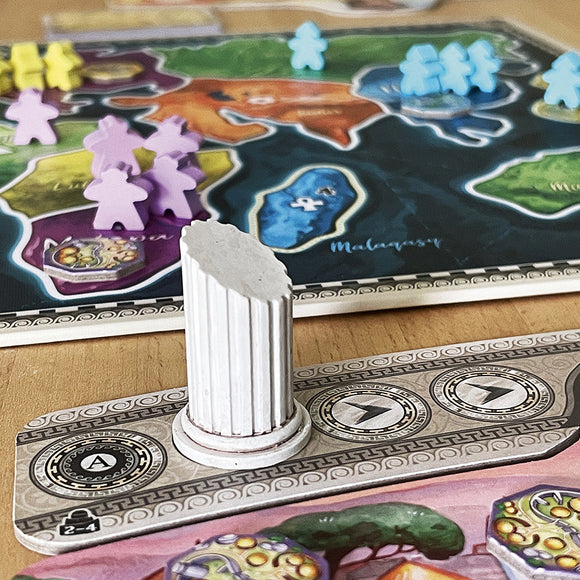 A close-up view of the board game 'First Empires' by Sand Castle. The image showcases a detailed game board featuring colorful regions representing different territories, with player pieces in purple, yellow, green, and blue. A white column piece stands on a scoring track, which includes icons and numbers for game progression.