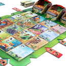 A colorful board game titled 'Meadow' by Rebel, showcasing an intricate game board filled with various illustrated cards featuring wildlife, landscapes, and plants. The game elements are arranged on a vibrant green background, inviting players to explore and strategize in a nature-themed adventure.