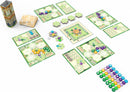 Azul: Queen's Garden board game by NEXT MOVE GAMES displayed on a white background. The game features colorful hexagonal tiles, player boards, and a central game board with a circular scoring track. Various token pieces in different colors are scattered across the playing area along with a storage tower and gameplay elements laid out strategically, illustrating the immersive design for competitive play.