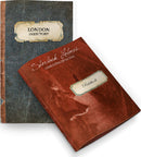 A close-up image featuring two booklets related to the board game 'Sherlock Holmes Consulting Detective: Jack the Ripper & West End Adventures'. The first booklet is titled 'London Directory' with a vintage design, while the second is labeled 'Sherlock Holmes Consulting Detective' showcasing an artistic depiction of Sherlock Holmes on the cover.