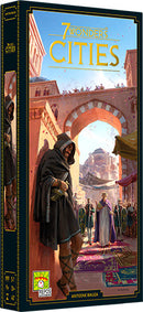 The boxed game '7 Wonders: Cities' by Asmodee depicts a vibrant illustration featuring a bustling market scene with a cloaked figure on the foreground and various characters in an ancient city setting. The title is prominently displayed at the top of the box.
