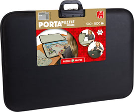 The PortaPuzzle Deluxe by Jumbo is a portable jigsaw puzzle case designed to accommodate puzzles ranging from 500 to 1000 pieces. The case features a sleek black exterior with a handle for easy transport. The packaging shows a woman comfortably assembling a puzzle, indicating the product's practicality and user-friendly design.