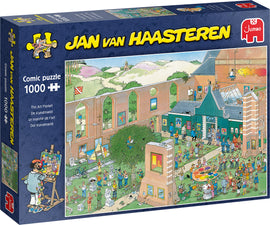 The Art Market jigsaw puzzle by Jumbo, featuring a vibrant comic illustration of an art market with numerous characters engaging in various artistic activities, showcasing a colorful setting filled with artwork and sculptures. The box displays the name of the puzzle and a depiction of the completed scene.