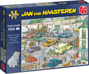 Jumbo Goes Shopping jigsaw puzzle by Jan van Haasteren featuring a colorful, busy street scene filled with people, cars, and an elephant. The box displays a comic-style illustration with various humorous elements in a shopping area, perfect for puzzle enthusiasts.