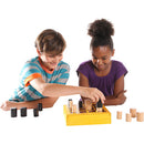 Two children playing the Gobblet game by Blue Orange U.S.A. The game features a yellow board with wooden pieces in beige and black, showcasing strategic gameplay.
