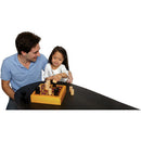 A father and daughter enjoying a game of Gobblet by Blue Orange U.S.A. The game is set on a black table, featuring a wooden game board with cylindrical pieces in black and natural wood colors. The child is playfully placing a piece on the board, while the parent watches her with a smile.