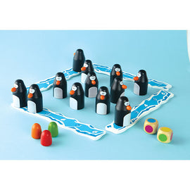 Pengoloo game by Blue Orange U.S.A., featuring colorful penguin figurines on a blue board. Children can roll dice and strategize to collect penguins. The game encourages fun interaction and develops critical thinking skills.